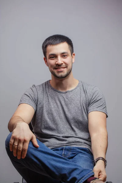 Awesome guy is sitting in relaxing pose — Stock Photo, Image