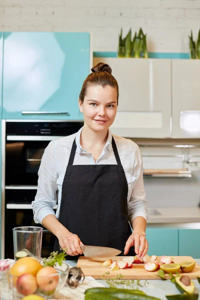 Hardworking wife is looking at the camera while cooking dinner for guests — Stock Photo, Image