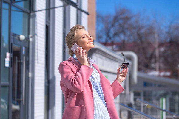 happy awesome woman looking up. love the life. optimistic girl pink coat