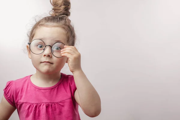 Beautiful red-haired girl touching her eyewear — Stock Photo, Image