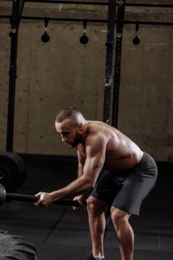 Antrenör çekiçle alıştırmaları gösteriyor.