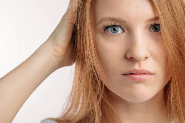 Serious redhair model holding her head. close up cropped photo — Stock Photo, Image