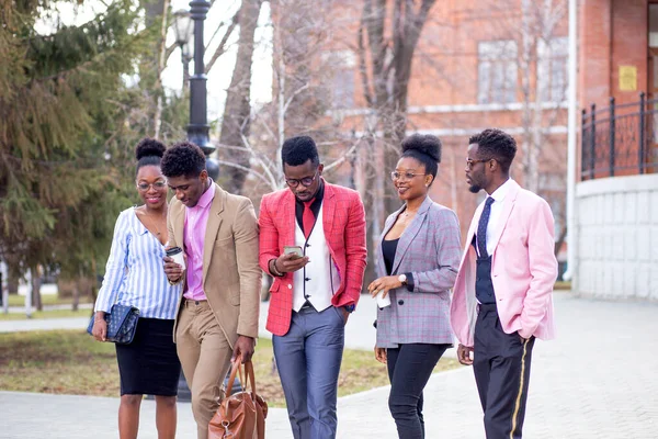 Leisure and teenage concept . a group of happy friends strolling on the street — Stock Photo, Image