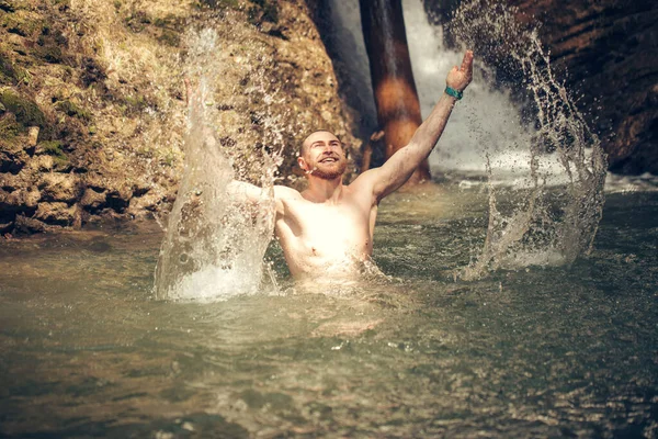 Banho turístico no lago rochoso da montanha, refrescando-se depois de uma longa caminhada — Fotografia de Stock