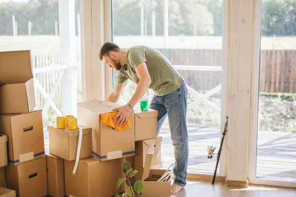 Happy Couple Carrying Cardboard Boxes Into New Home On Moving Day