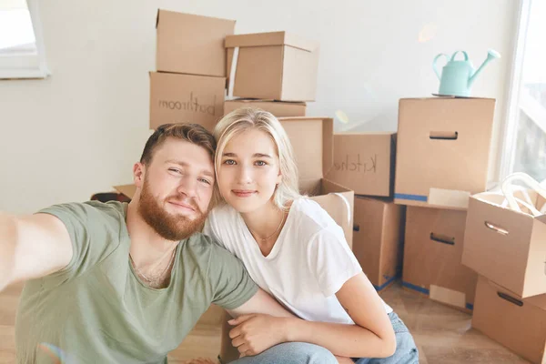 Pareja mudándose a nuevo apartamento juntos reubicación y tomando selfie — Foto de Stock