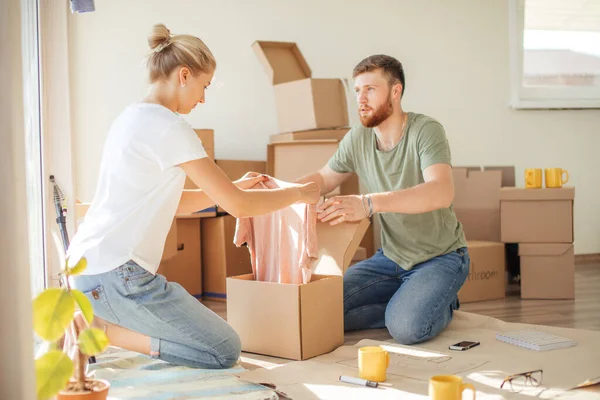 Pareja en apartamento nuevo desembalaje cajas de cartón — Foto de Stock