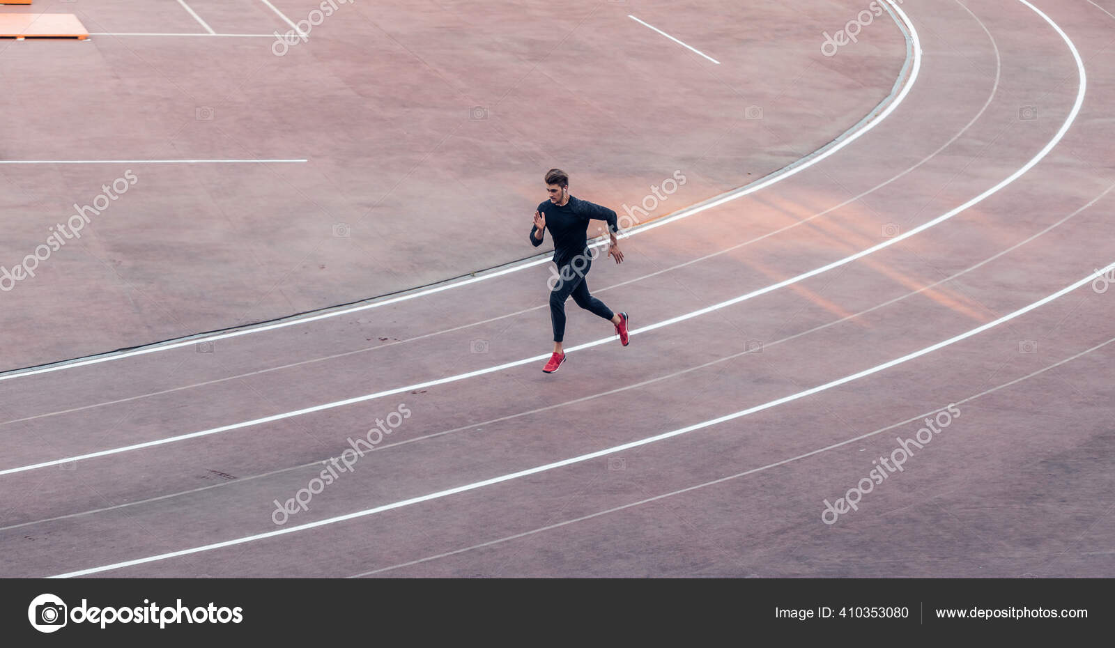 Top view Athlete running on running track. Runner sprinting on red