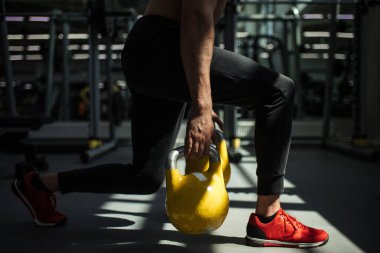 Genç fitness adamı Kettlebell 'de antrenman yapıyor..