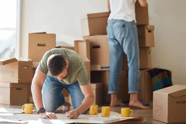 Casal procurando plantas de sua nova casa. Planejamento de interiores — Fotografia de Stock