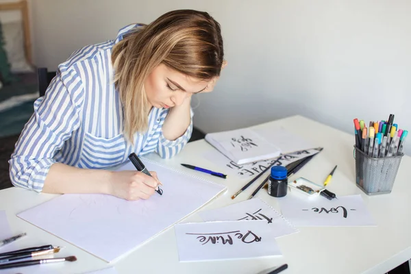 Mujer hacer escritos de caligrafía, hacer arte sobre papel usando el pincel de pluma signo —  Fotos de Stock