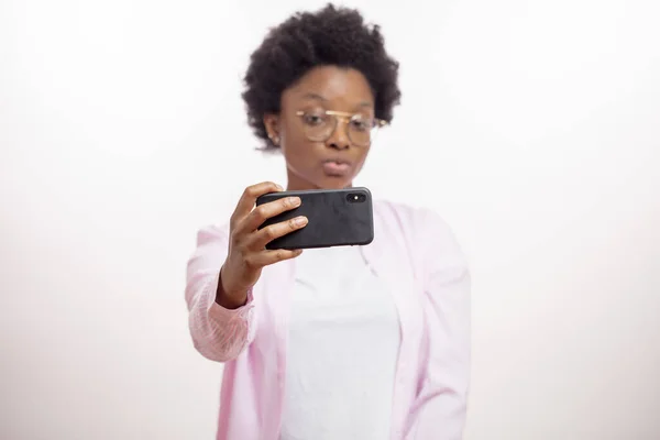 pretty young afro woman posing to her cell phone