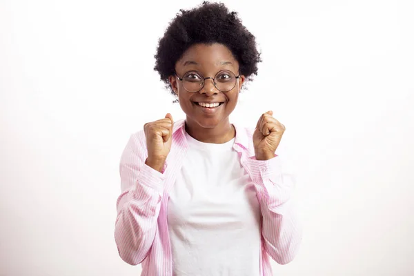 Glückliche erfolgreiche Afrikanerin mit erhobenen geballten Fäusten feiert Erfolg — Stockfoto