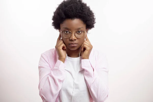 Serios Afro-Frau setzt Kopfhörer auf — Stockfoto