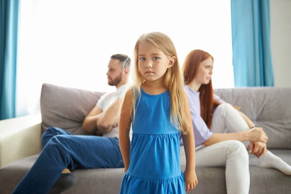 Adorable child girl between depressed offended on each other parents — Stock Photo, Image