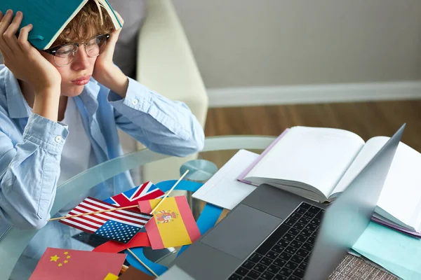 Sad schoolboy tired of studying online — Stock Photo, Image
