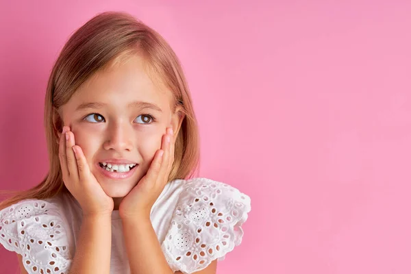 Pretty caucasian little girl is dreaming about new toy — Stock Photo, Image