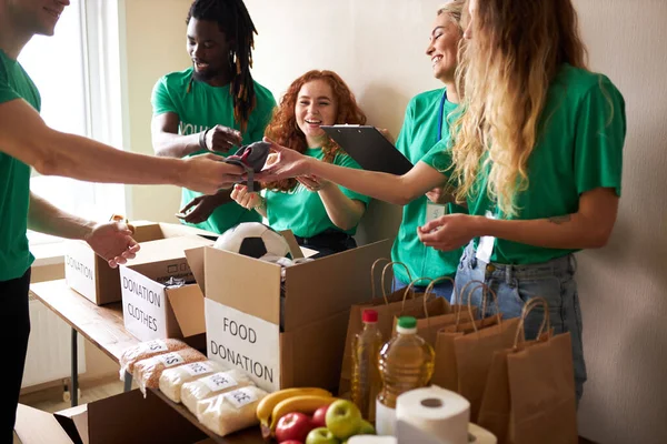 active young people enjoys volunteering at food and clothes bank