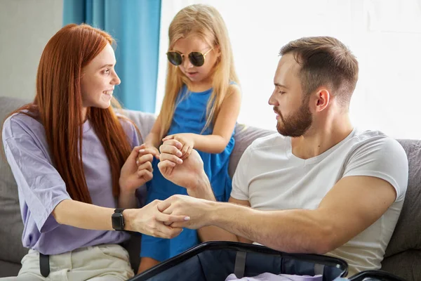 Familia caucásica con niña discutir qué llevar con ellos para las vacaciones, vacaciones — Foto de Stock