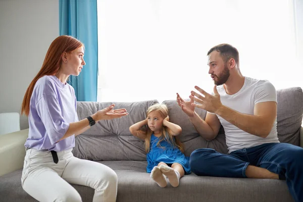 Child girl is suffering from quarrels between parents in the family at home — Stock Photo, Image