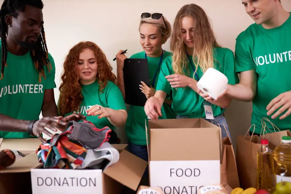 young enthusiastic volunteers with donations for poor people