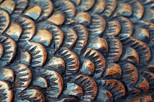 cutter carves the fish from the wood. wood carving closeup. Fish scale.