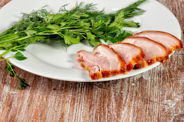 Gerookt vlees ligt op tafel met kruiden en saus — Stockfoto