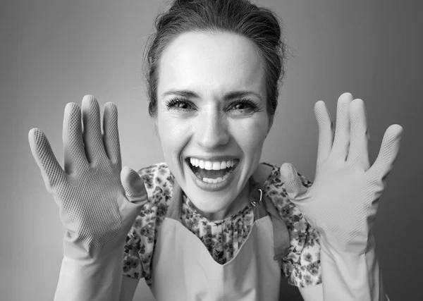 Smiling Modern Woman Apron Showing Rubber Gloves — Stock Photo, Image