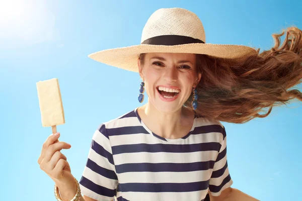 青空アイス棒を麦わらで陽気なトレンディな女性 — ストック写真