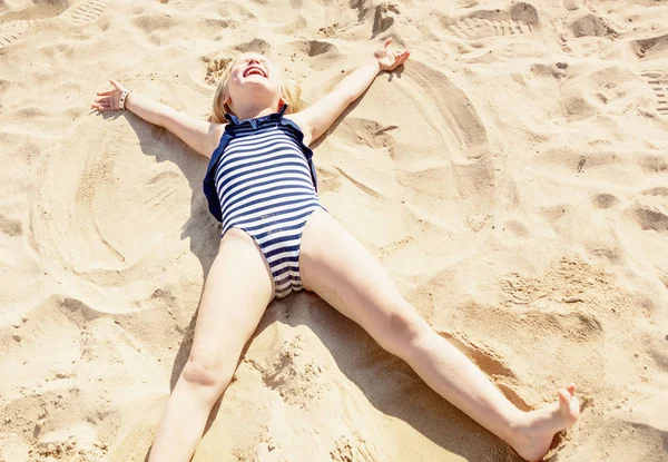 Happy Girl Swimsuit Laying Sand Making Angel Seashore — Stock Photo, Image