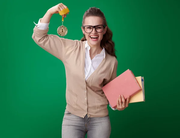Uśmiechnięta Kobieta Młody Student Książek Wyświetlono Medal Biceps Zielonym Tle — Zdjęcie stockowe