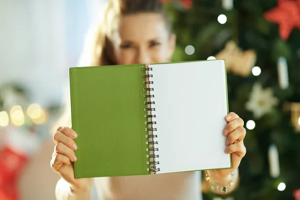 Stylish Housewife Showing Green Notebook Open Blank Page Christmas Tree — Stock Photo, Image