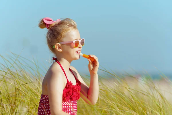 Trendy Girl Red Swimwear Applying Lipstick Spf Ocean Coast Protect — Stock Photo, Image