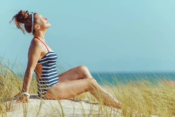 Relaxed Modern Woman Striped Swimsuit Sitting Seacoast Total Relaxation Best — Stock Photo, Image