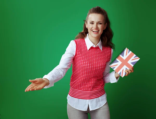 learner woman with United Kingdom flag coloured notebook invitin