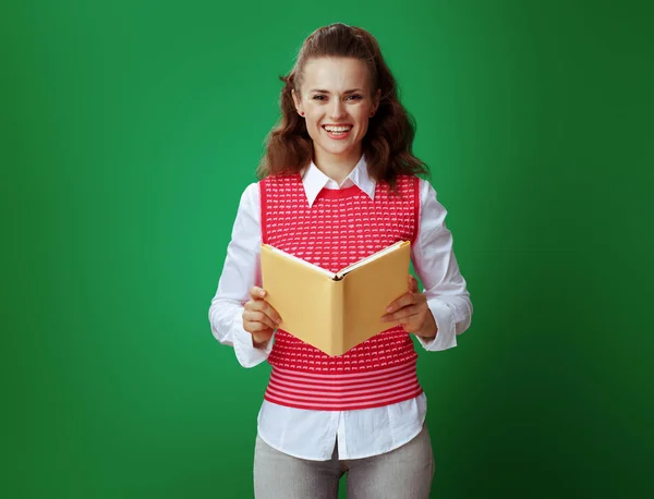 Learner woman with opened book isolated on chalkboard green — Stock Photo, Image