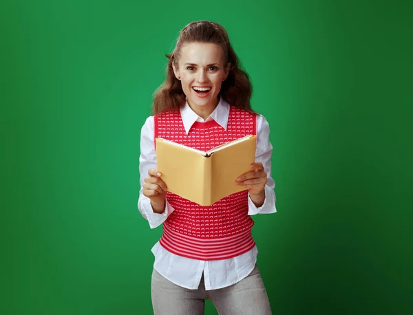 Happy healthy student woman holding opened yellow book — Stock Photo, Image