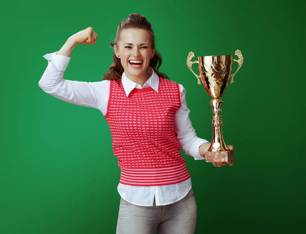 Happy fit student with golden goblet showing biceps — Stock Photo, Image