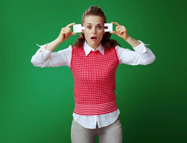 Confused healthy student trying to assemble 2 pieces of puzzle — Stock Photo, Image