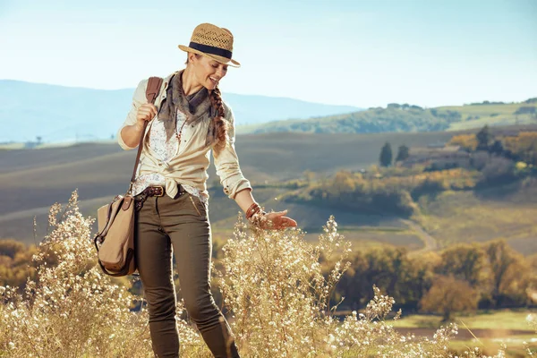happy solo traveller woman enjoying summer Tuscany trekking