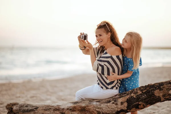 Mutter und Tochter Touristen sitzen auf einem hölzernen Haken und nehmen — Stockfoto