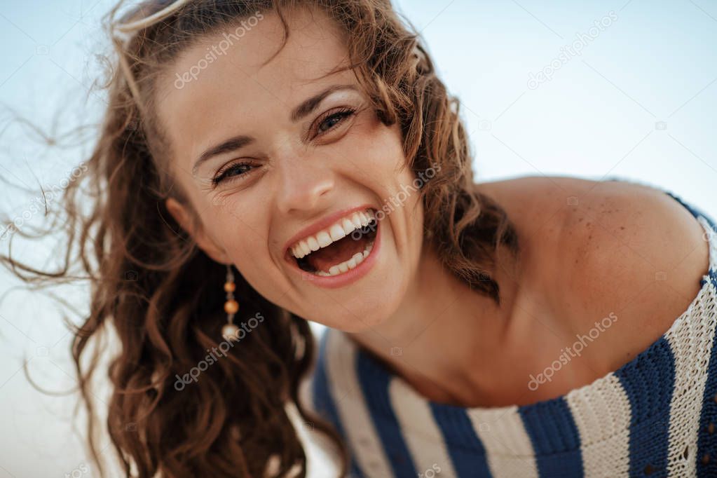 Portrait of happy young woman at summer outdoors
