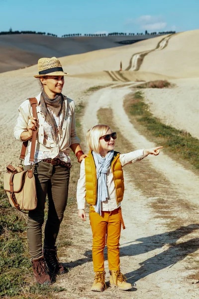 Caminhantes felizes em forma de mãe e criança apontando para algo — Fotografia de Stock