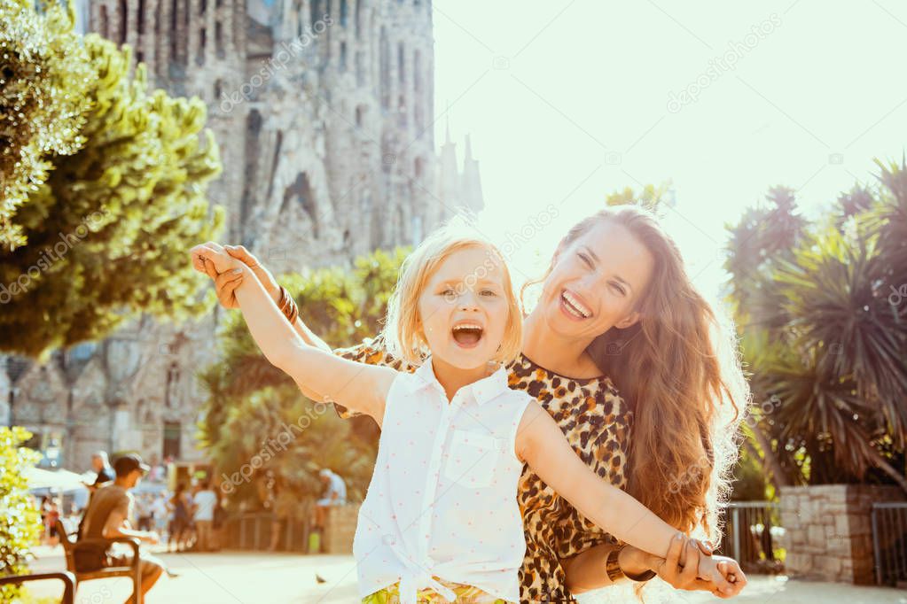 mother and daughter not far from La Sagrada Familia rejoicing