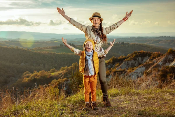 Happy young mother and daughter in Tuscany, Italy rejoicing — стоковое фото
