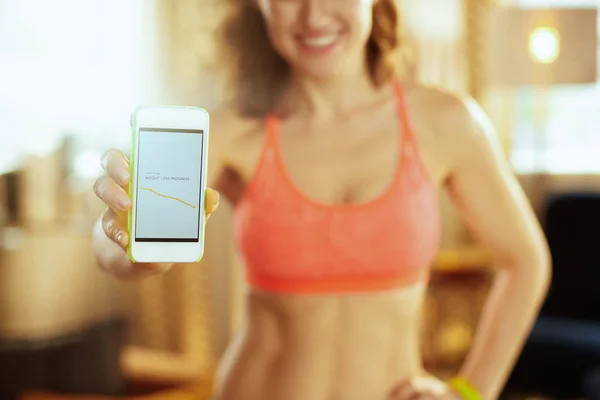 Closeup on phone screen with fit app in hand of healthy woman — Stock Photo, Image