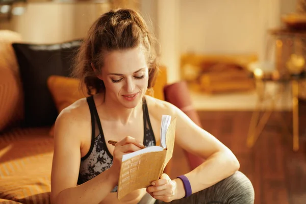 Glückliche Gesunde Frau Fitnesskleidung Mit Tagebuch Und Stift Die Fitnessziele — Stockfoto