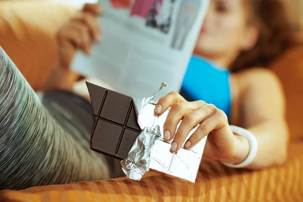 Closeup Chocolate Bar Hands Fit Woman Laying Sofa Magazine Modern — Stock Photo, Image