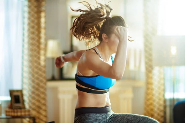 Mujer deportiva activa en ropa deportiva en el entrenamiento de la casa moderna — Foto de Stock