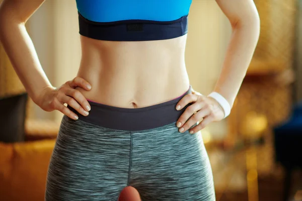 Closeup on healthy woman in sport clothes at modern home